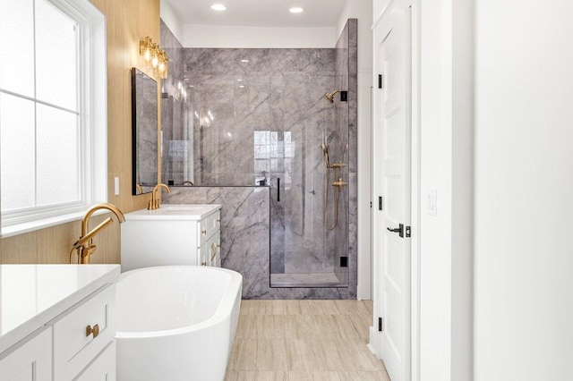 bathroom featuring vanity, shower with separate bathtub, and a wealth of natural light