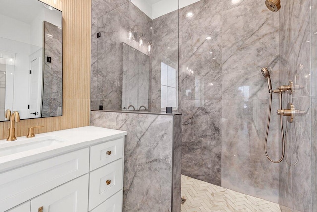 bathroom with vanity and tiled shower