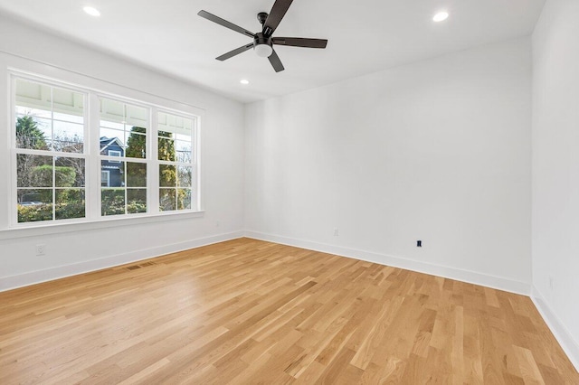 empty room with light hardwood / wood-style floors and ceiling fan