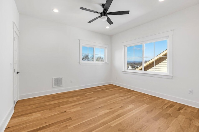 spare room featuring light hardwood / wood-style flooring and ceiling fan