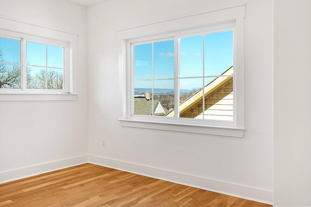 empty room with hardwood / wood-style flooring