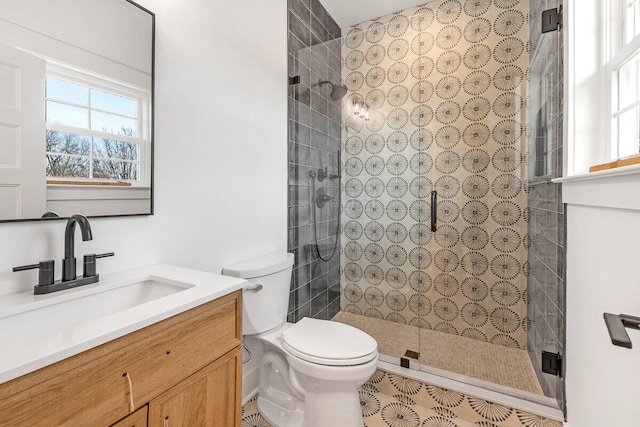 bathroom with vanity, a wealth of natural light, an enclosed shower, and toilet