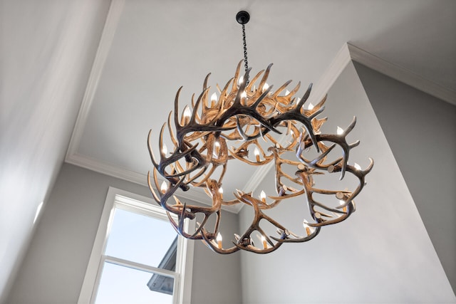 interior details with a notable chandelier and crown molding