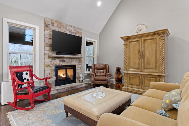 living room featuring high vaulted ceiling, a fireplace, and dark hardwood / wood-style flooring