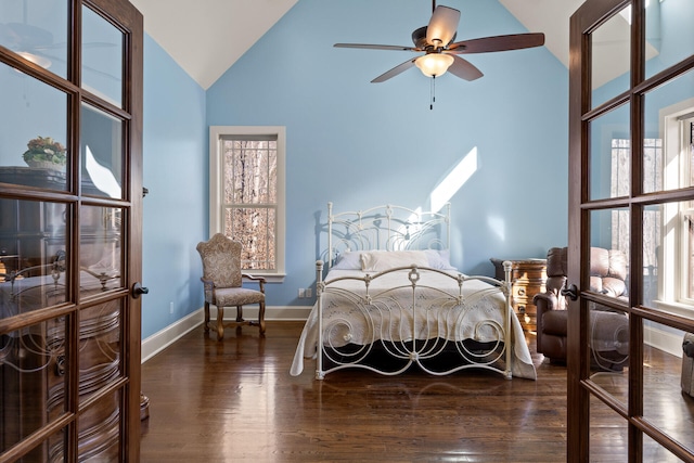 bedroom featuring dark wood-type flooring, ceiling fan, lofted ceiling, and multiple windows