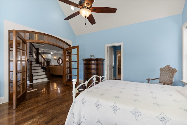 bedroom featuring dark wood-type flooring, vaulted ceiling, french doors, and ceiling fan