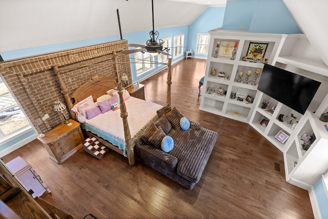 bedroom with lofted ceiling and dark hardwood / wood-style floors