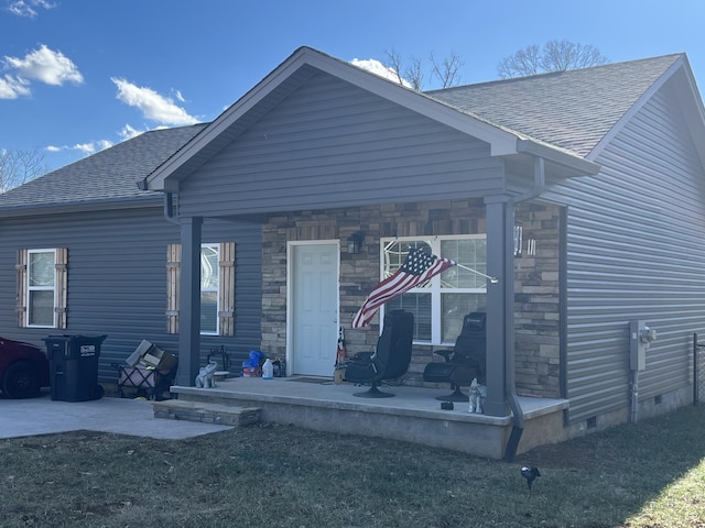 back of property with a porch and a lawn