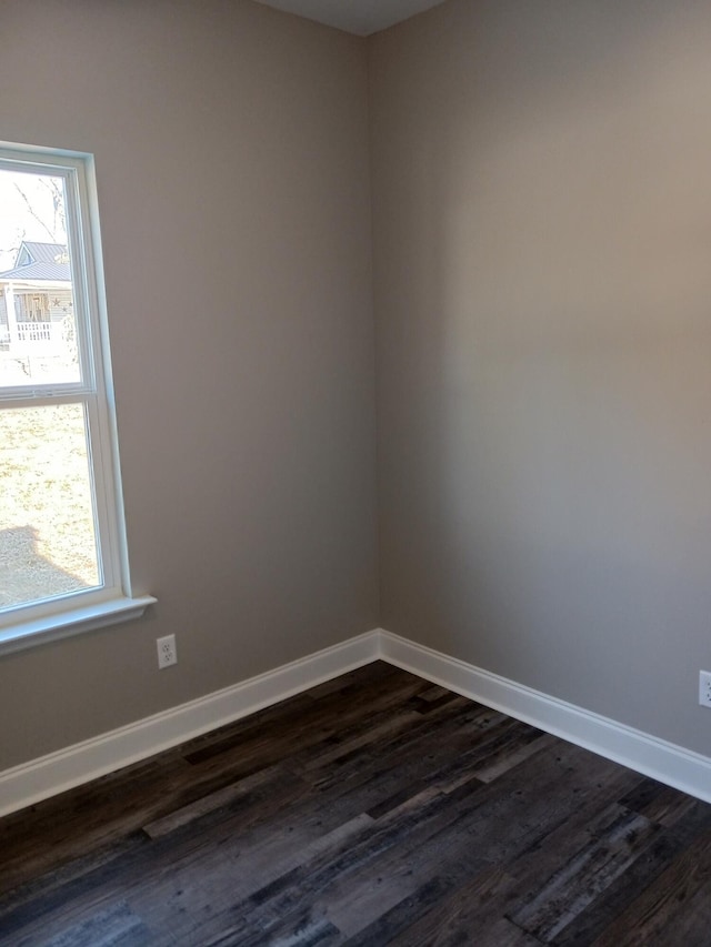 spare room featuring dark wood-type flooring