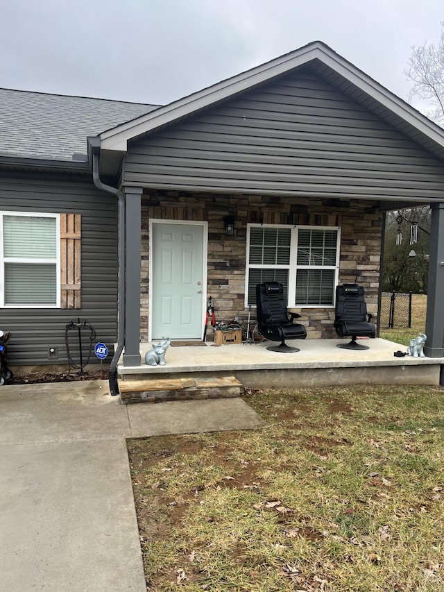 doorway to property featuring a yard and a patio area