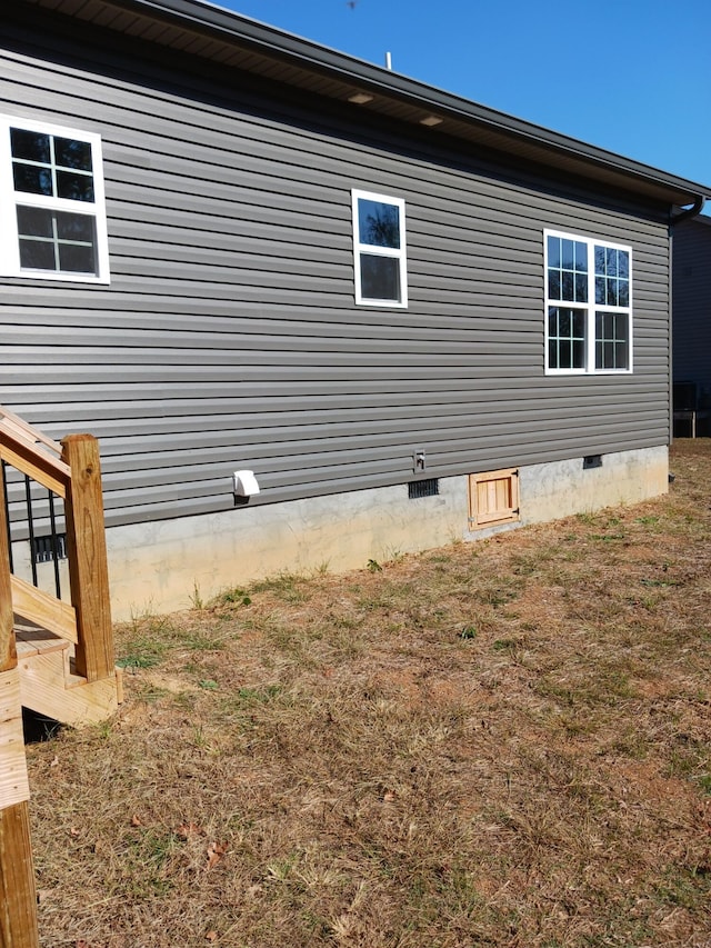 view of side of home featuring a lawn