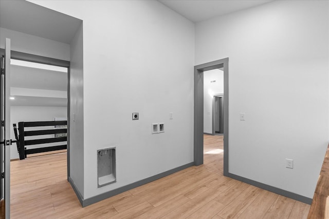 interior space with washer hookup, light wood-style floors, hookup for an electric dryer, laundry area, and baseboards