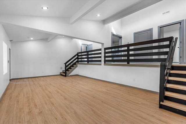 interior space with vaulted ceiling with beams, recessed lighting, visible vents, wood finished floors, and stairs