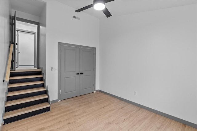 unfurnished bedroom featuring a ceiling fan, wood finished floors, visible vents, and baseboards