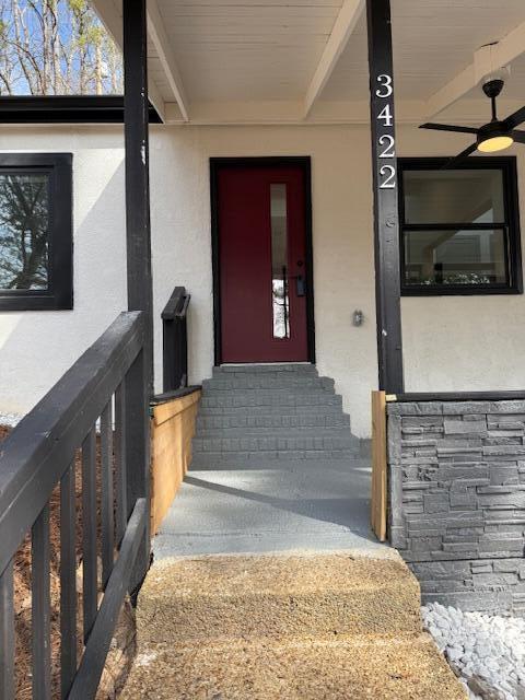 doorway to property featuring stucco siding