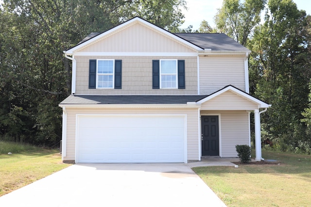 view of front of property featuring a garage and a front lawn