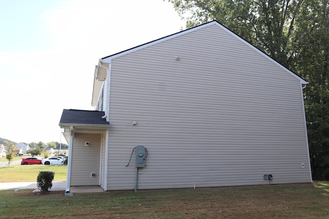 view of property exterior with a yard