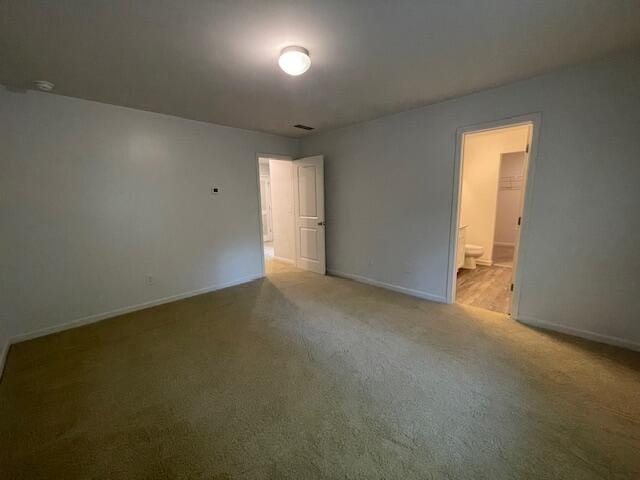 spare room featuring light carpet