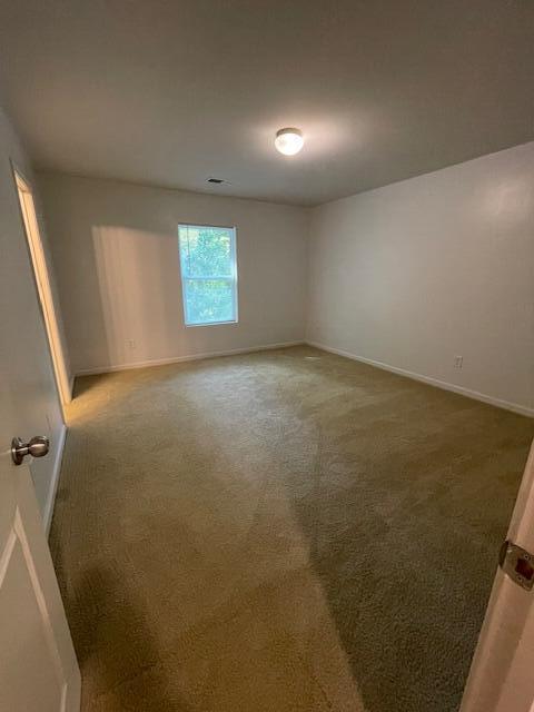 unfurnished room featuring carpet