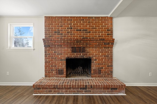 room details featuring hardwood / wood-style flooring, a fireplace, and ornamental molding