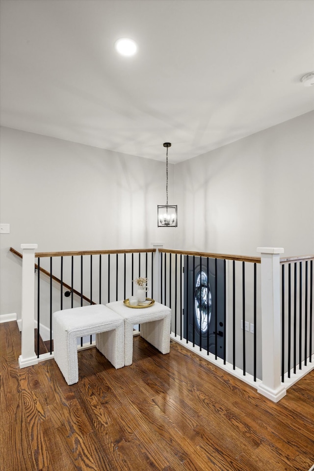 corridor featuring hardwood / wood-style floors and a chandelier