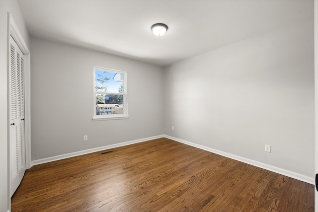 unfurnished bedroom with hardwood / wood-style floors and a closet