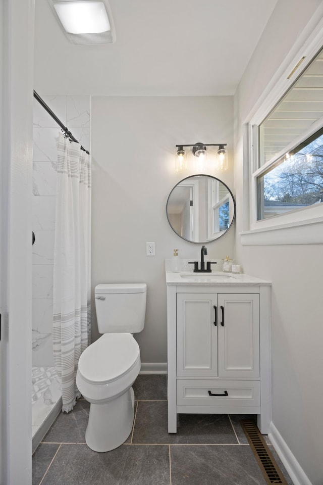 bathroom with vanity, toilet, and walk in shower