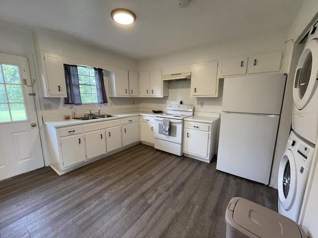 kitchen featuring stacked washer and dryer, sink, dark hardwood / wood-style floors, white appliances, and white cabinets