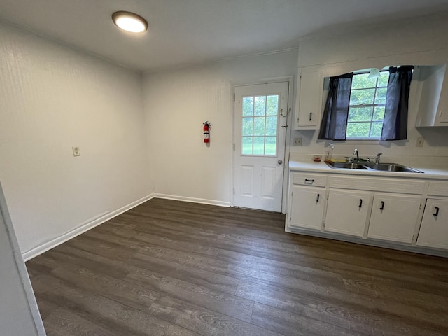 kitchen with dark hardwood / wood-style floors, sink, and white cabinets