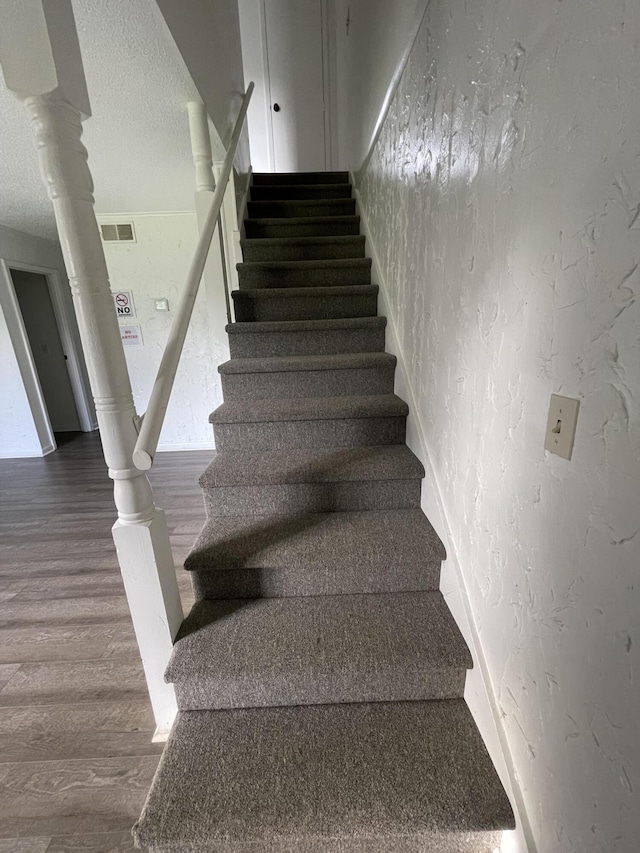 stairway with hardwood / wood-style flooring