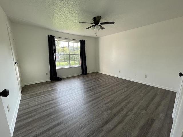 spare room featuring dark hardwood / wood-style floors, a textured ceiling, and ceiling fan