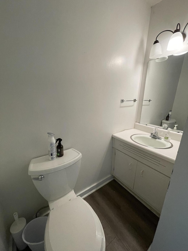 bathroom with vanity, hardwood / wood-style floors, and toilet