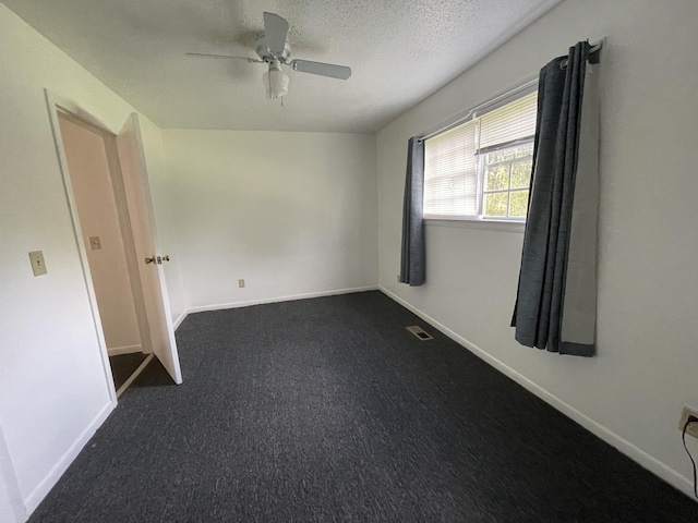 empty room featuring ceiling fan and a textured ceiling