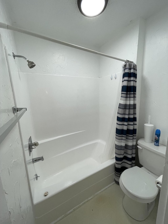 bathroom featuring shower / bathtub combination with curtain and toilet