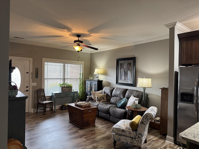 living room featuring crown molding, dark wood-type flooring, and ceiling fan