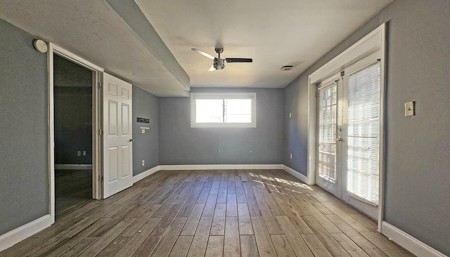 spare room with hardwood / wood-style floors and ceiling fan