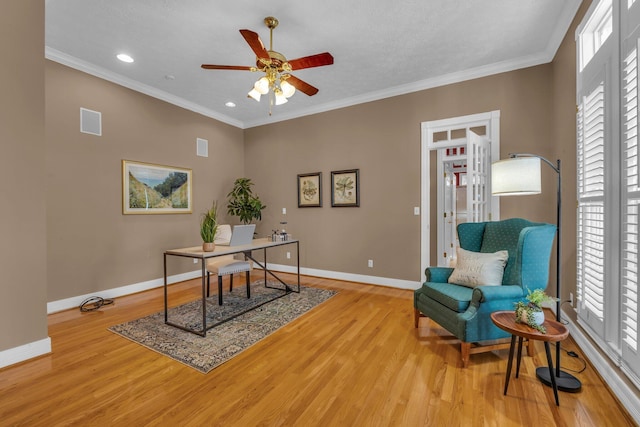 office space featuring crown molding, ceiling fan, and light hardwood / wood-style floors