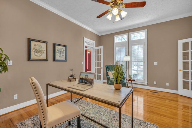 office space featuring french doors, crown molding, a textured ceiling, and hardwood / wood-style flooring