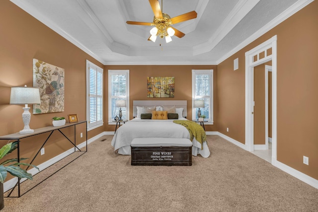 bedroom featuring ornamental molding, a raised ceiling, ceiling fan, and carpet