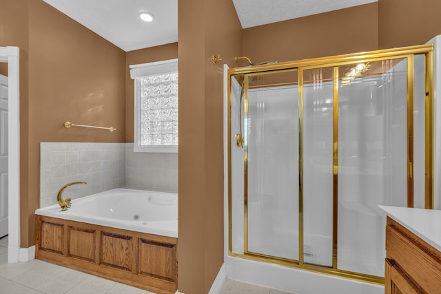 bathroom featuring vanity, tile patterned floors, and shower with separate bathtub