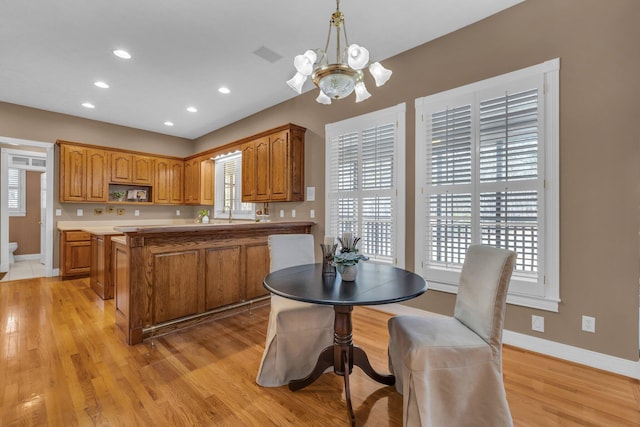 kitchen with pendant lighting, a center island, and light hardwood / wood-style floors