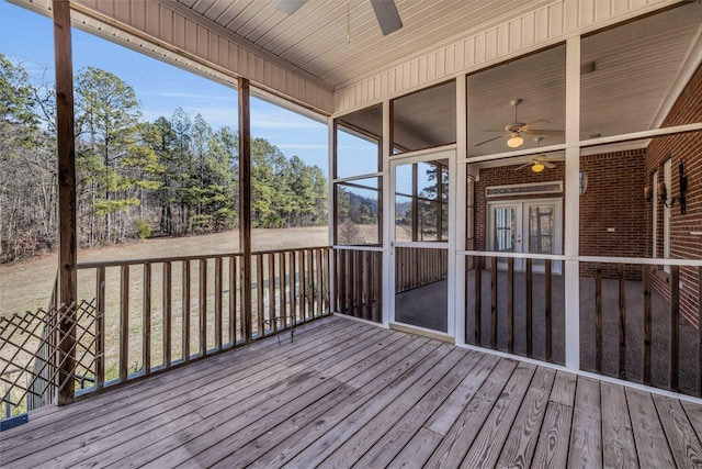 unfurnished sunroom featuring plenty of natural light and ceiling fan