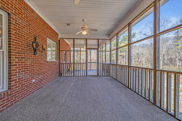 unfurnished sunroom featuring ceiling fan