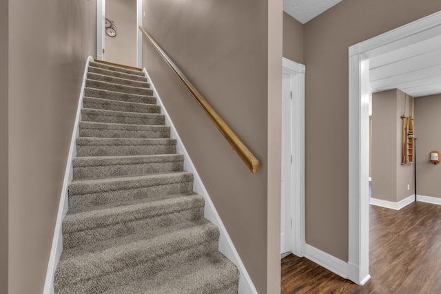 staircase with wood-type flooring