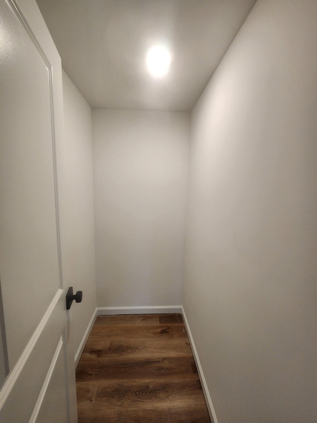 interior space with wood finished floors and baseboards