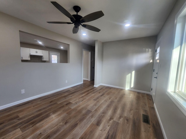 empty room with ceiling fan and hardwood / wood-style floors