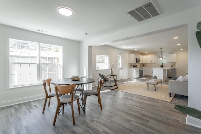 dining space with plenty of natural light and light hardwood / wood-style floors