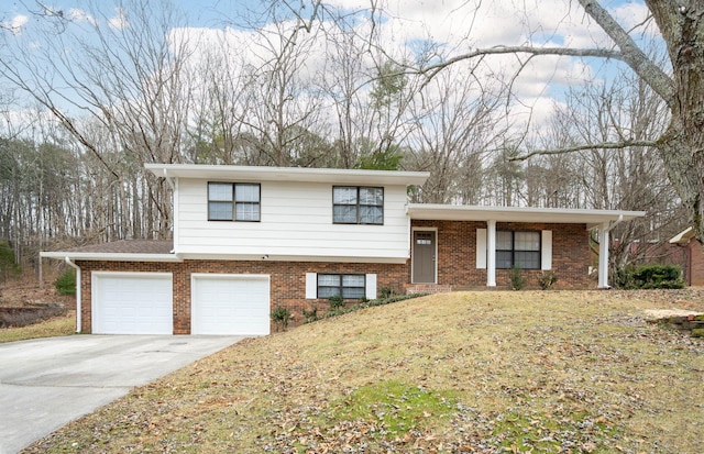 tri-level home featuring a garage and a front lawn