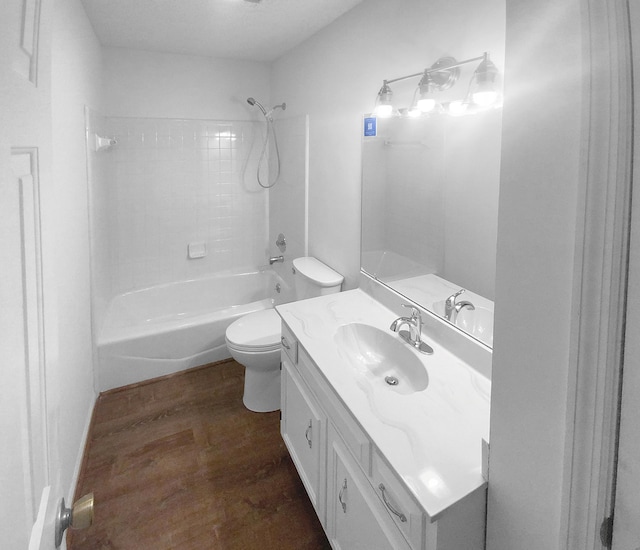 full bathroom featuring hardwood / wood-style flooring, vanity, tub / shower combination, and toilet