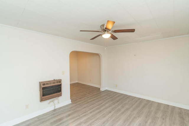 unfurnished living room with heating unit, crown molding, light hardwood / wood-style floors, and ceiling fan